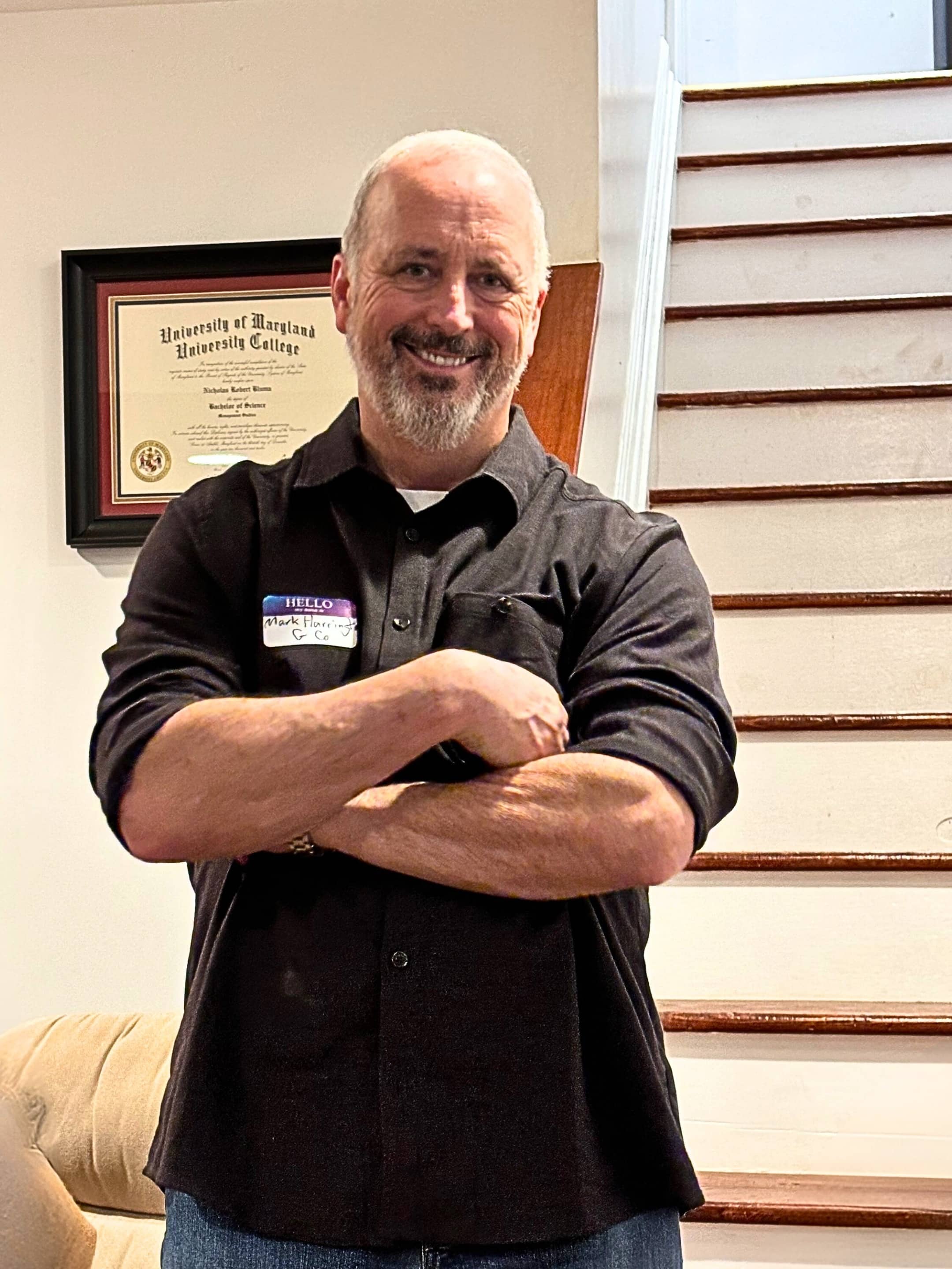Tun Tavern Fellowship Missionary Mark Harrington Stands by a staircase.