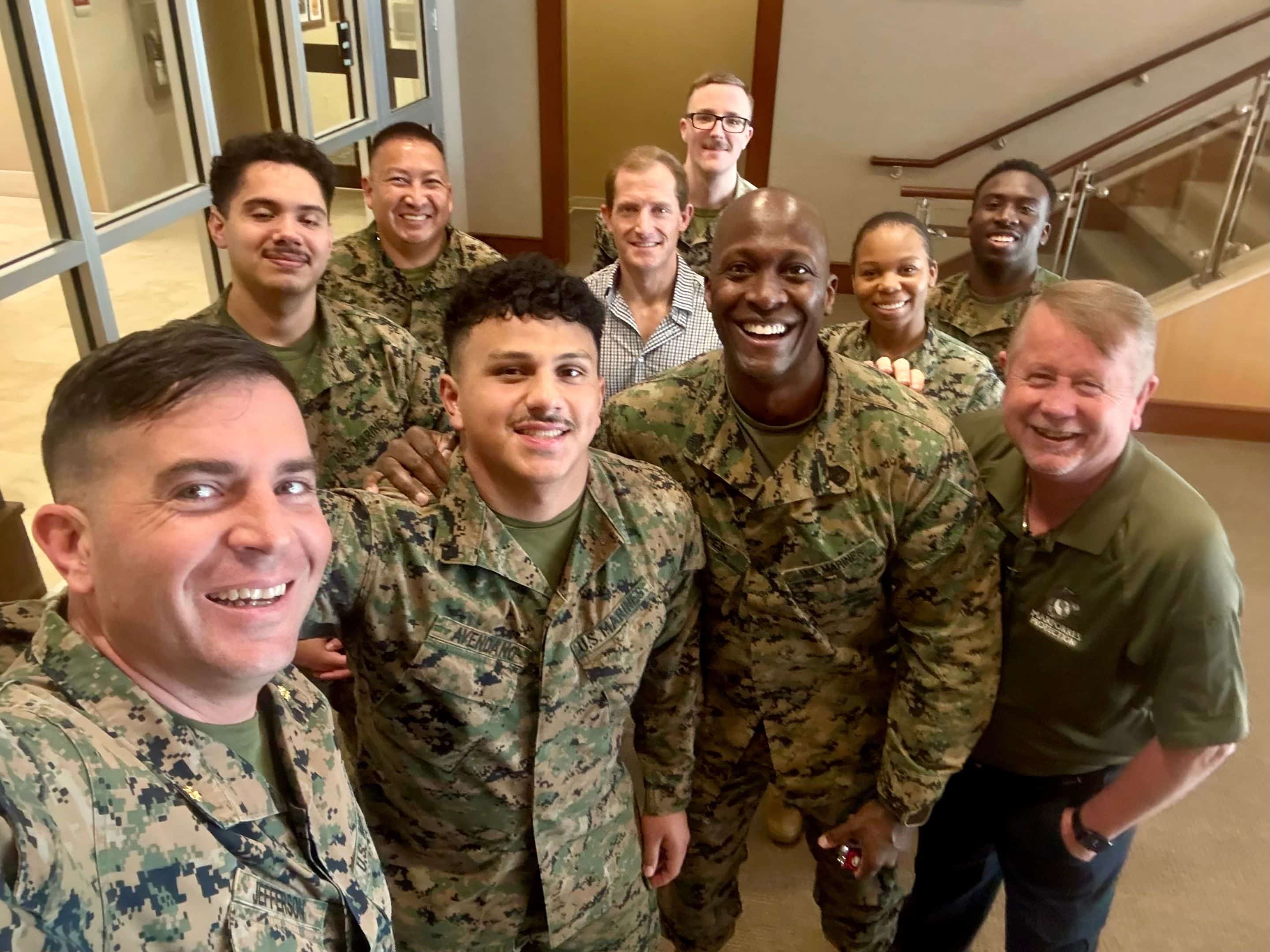 Three local base leaders at Quantico smile at the camera